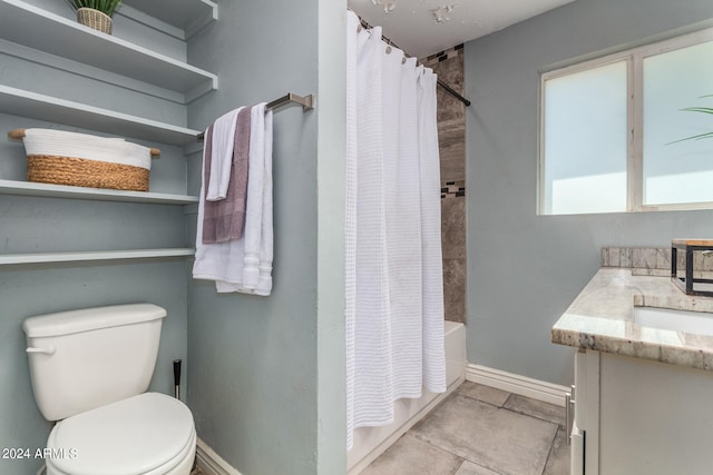 full bathroom featuring vanity, shower / bath combo with shower curtain, toilet, and tile patterned floors