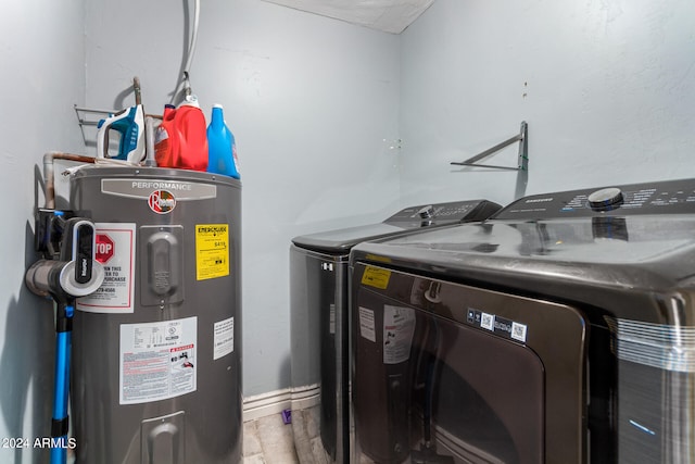 washroom featuring water heater, independent washer and dryer, and hardwood / wood-style floors