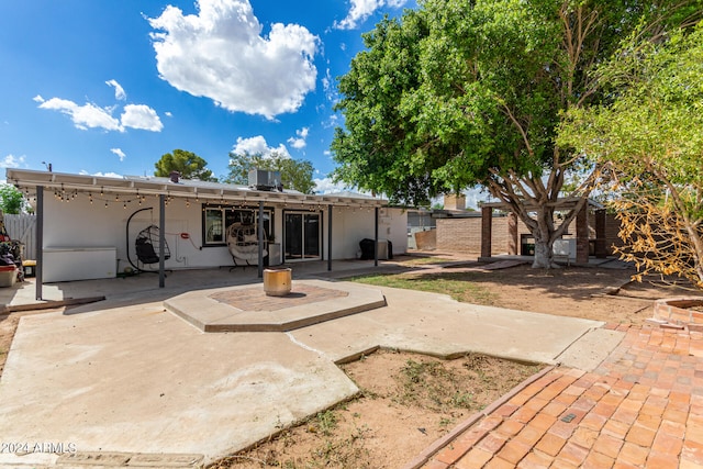 back of house with a patio area and central AC