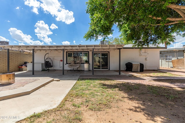 rear view of property with a pergola and a patio