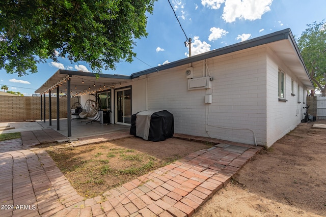 rear view of house featuring a pergola and a patio area