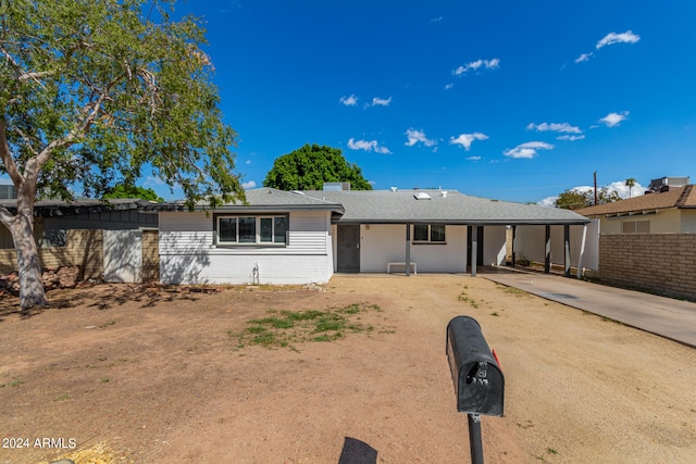 ranch-style home featuring a carport