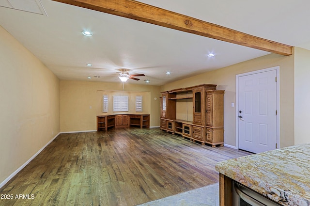 unfurnished living room with beam ceiling, dark hardwood / wood-style flooring, and ceiling fan