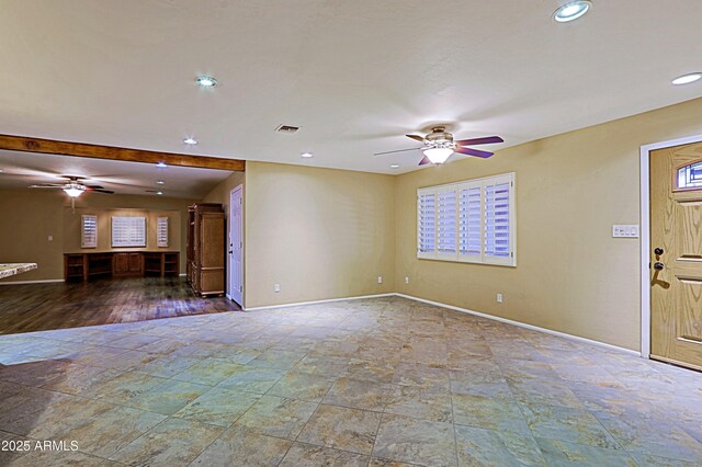 unfurnished living room with ceiling fan