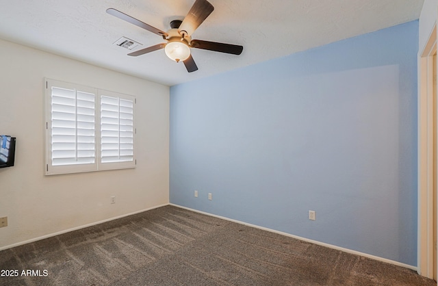 unfurnished room featuring dark colored carpet