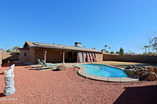 view of swimming pool with a fire pit and a patio area