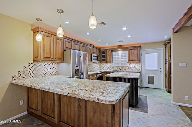 kitchen featuring decorative light fixtures, light stone counters, kitchen peninsula, backsplash, and appliances with stainless steel finishes