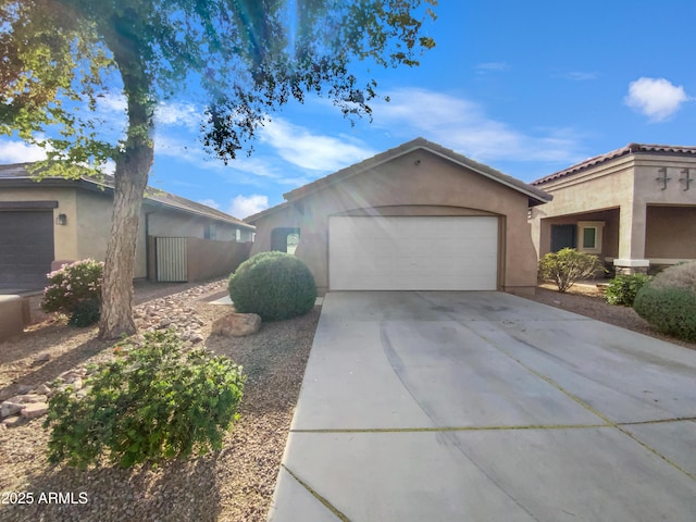 19282 N Toledo Ave, Maricopa, AZ 85138 - view of front facade with stucco siding, a garage, and concrete driveway