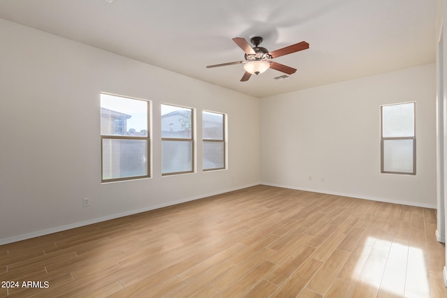 empty room featuring ceiling fan and light hardwood / wood-style floors