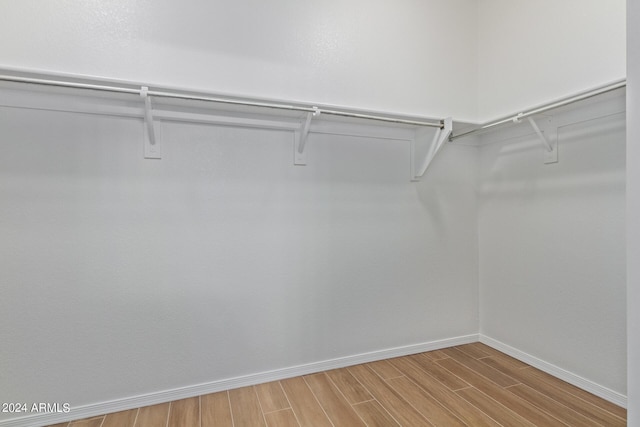 spacious closet featuring wood finished floors