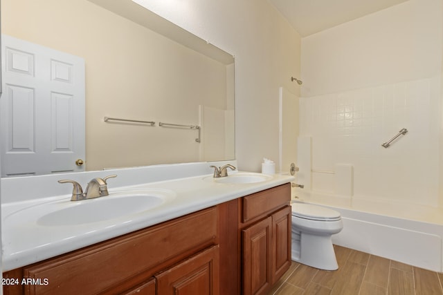 full bathroom with shower / bathing tub combination, double vanity, and toilet