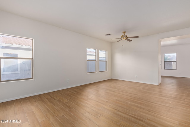 unfurnished room with light hardwood / wood-style flooring and ceiling fan