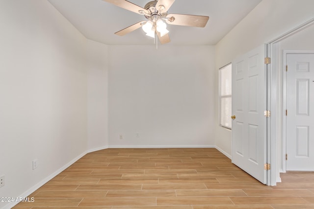 spare room featuring ceiling fan and light wood-type flooring