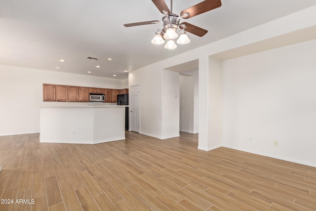 unfurnished living room with ceiling fan and light wood-type flooring