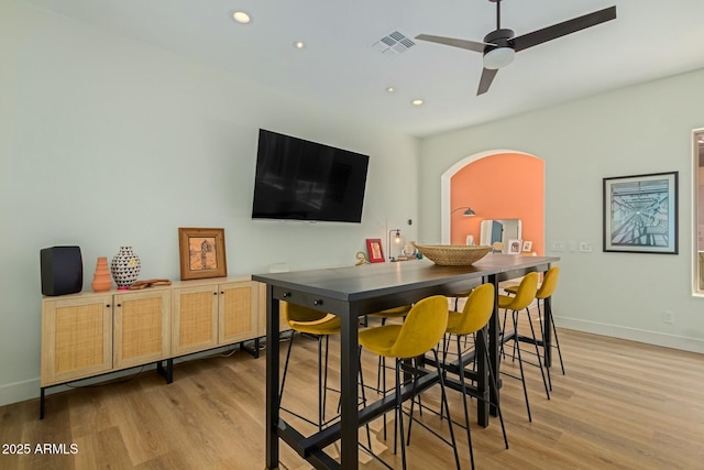 dining room with light hardwood / wood-style floors and ceiling fan