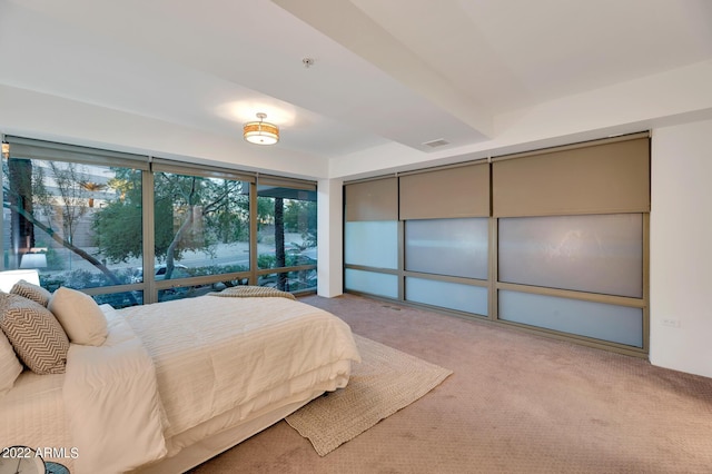 carpeted bedroom featuring visible vents