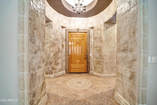 bathroom featuring a notable chandelier and tile patterned floors