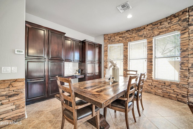 dining area with light tile patterned floors and visible vents