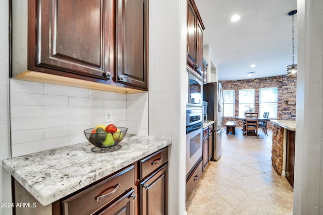 kitchen with light stone counters, recessed lighting, decorative backsplash, appliances with stainless steel finishes, and dark brown cabinetry