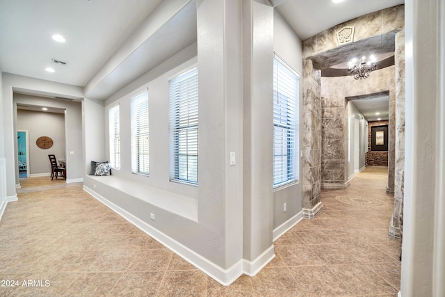 hallway featuring tile patterned flooring and baseboards