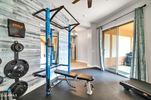 exercise area with ceiling fan and baseboards