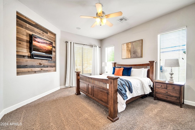 bedroom with light carpet, baseboards, visible vents, and ceiling fan