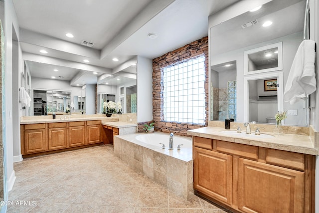 bathroom featuring a bath, visible vents, a tile shower, and a sink