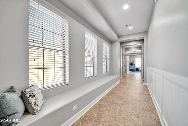 corridor featuring light tile patterned floors, baseboards, and recessed lighting