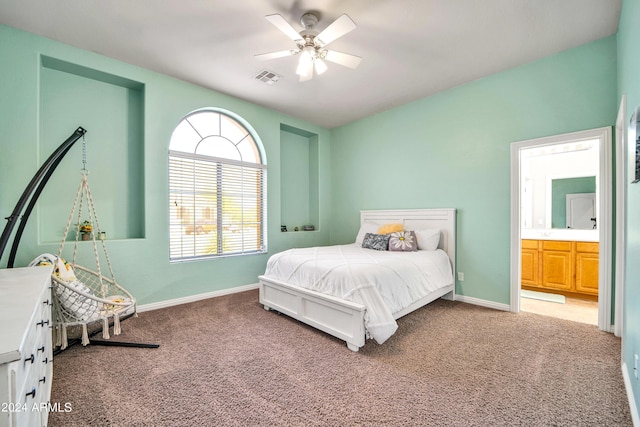 bedroom featuring carpet floors, ensuite bath, visible vents, and baseboards