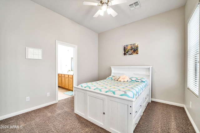 carpeted bedroom with baseboards, visible vents, a ceiling fan, and ensuite bathroom