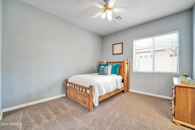 bedroom with light carpet, a ceiling fan, visible vents, and baseboards