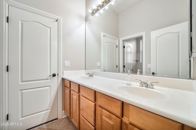 full bathroom with tile patterned flooring, a sink, and double vanity