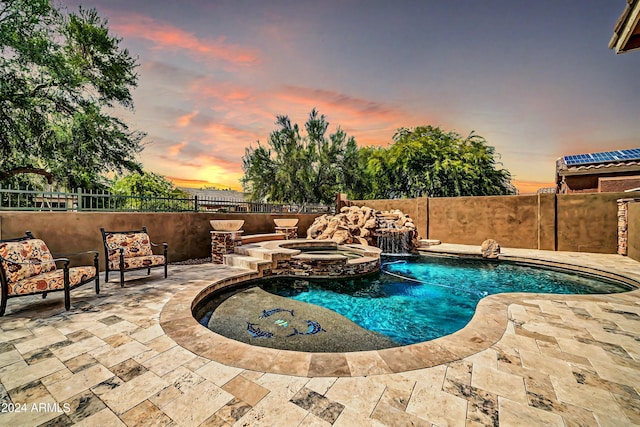 view of swimming pool with a patio, a fenced backyard, and a pool with connected hot tub