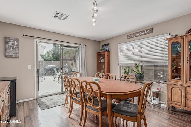 dining area with wood finished floors and baseboards