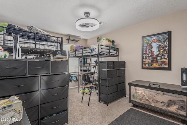 bedroom featuring carpet, an office area, and a textured ceiling