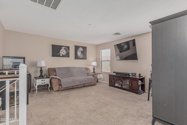 living room featuring carpet, a textured ceiling, and baseboards