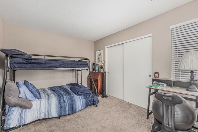 carpeted bedroom featuring a closet