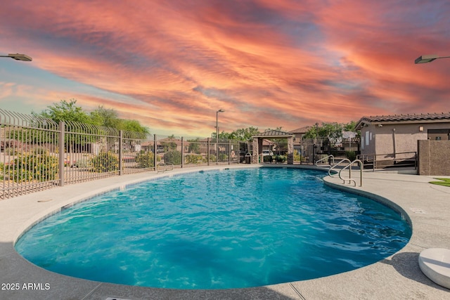 community pool with fence and a patio