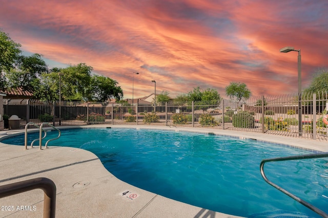 community pool with fence and a patio