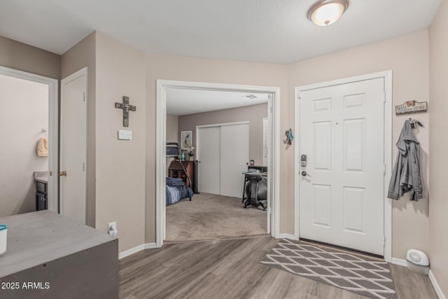 entrance foyer featuring wood finished floors and baseboards