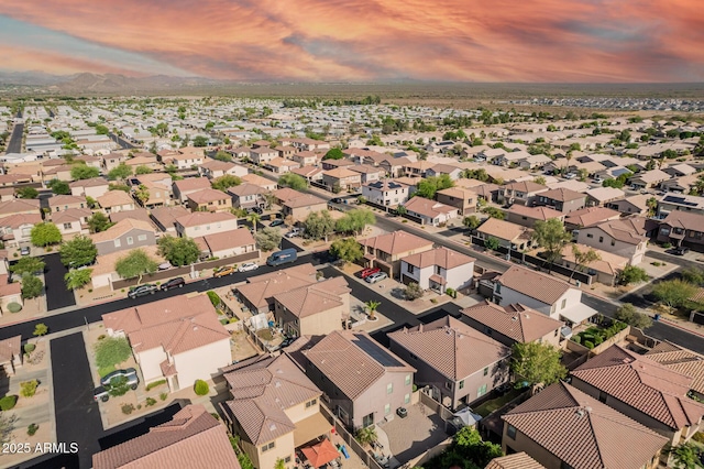 aerial view of property and surrounding area featuring nearby suburban area