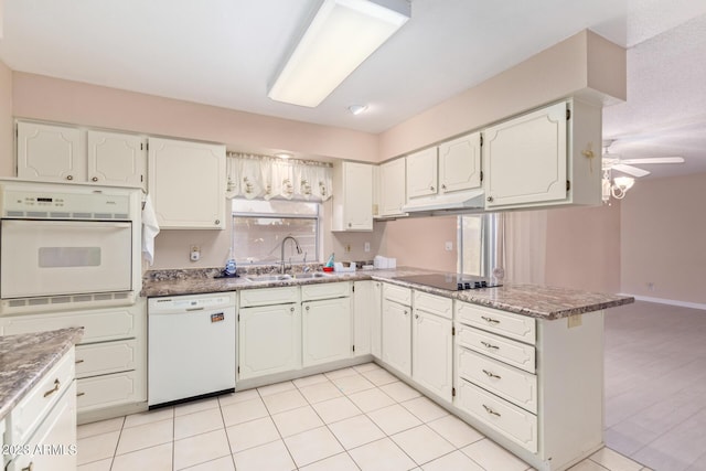 kitchen with white appliances, white cabinetry, and sink