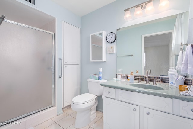 bathroom with tile patterned flooring, vanity, toilet, and a shower with shower door