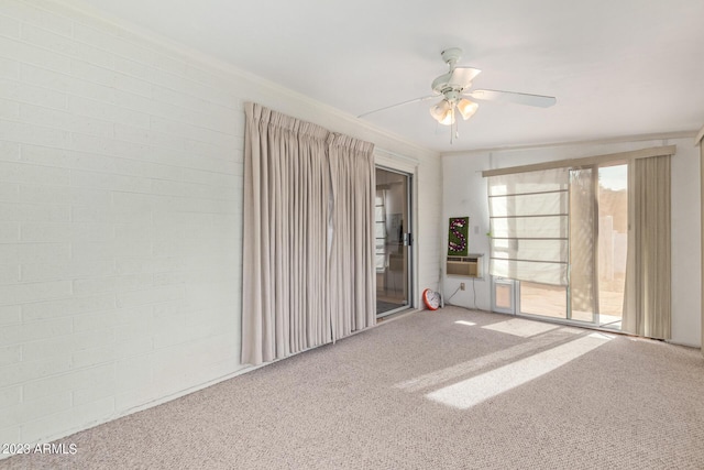 spare room with ceiling fan and carpet