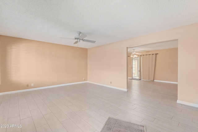 empty room featuring ceiling fan and a textured ceiling