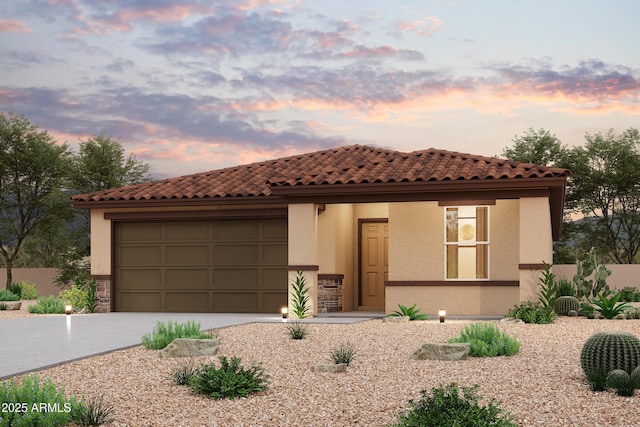 1795 Yance Dr, Wickenburg, AZ 85390 - mediterranean / spanish-style home featuring concrete driveway, a garage, stucco siding, and a tile roof