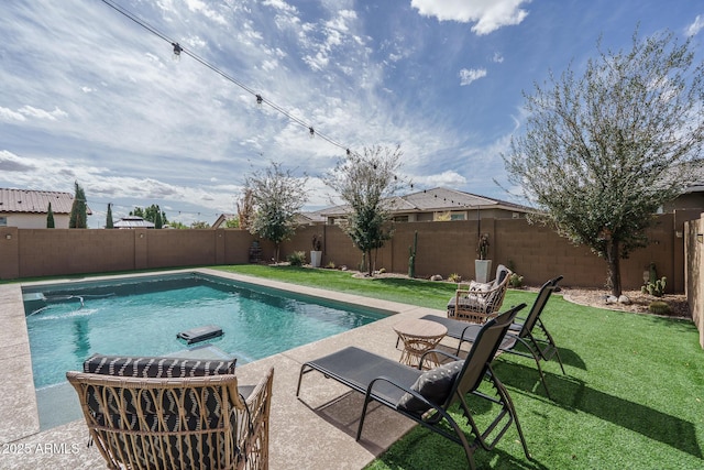 view of swimming pool with a patio, a lawn, a fenced in pool, and a fenced backyard