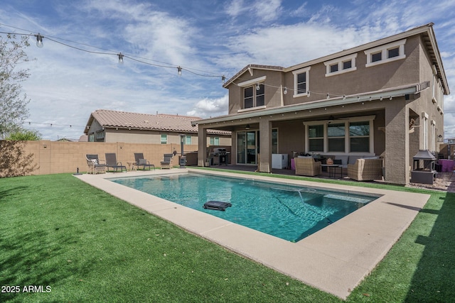 back of property with stucco siding, an outdoor hangout area, a lawn, a fenced backyard, and a patio area