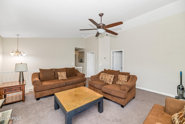 living room featuring lofted ceiling, carpet flooring, ceiling fan, baseboards, and a chandelier
