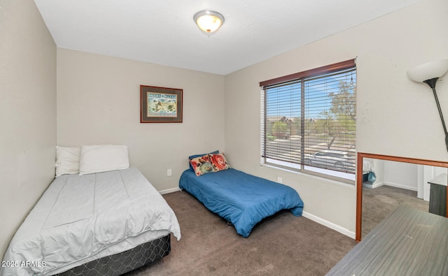carpeted bedroom featuring baseboards